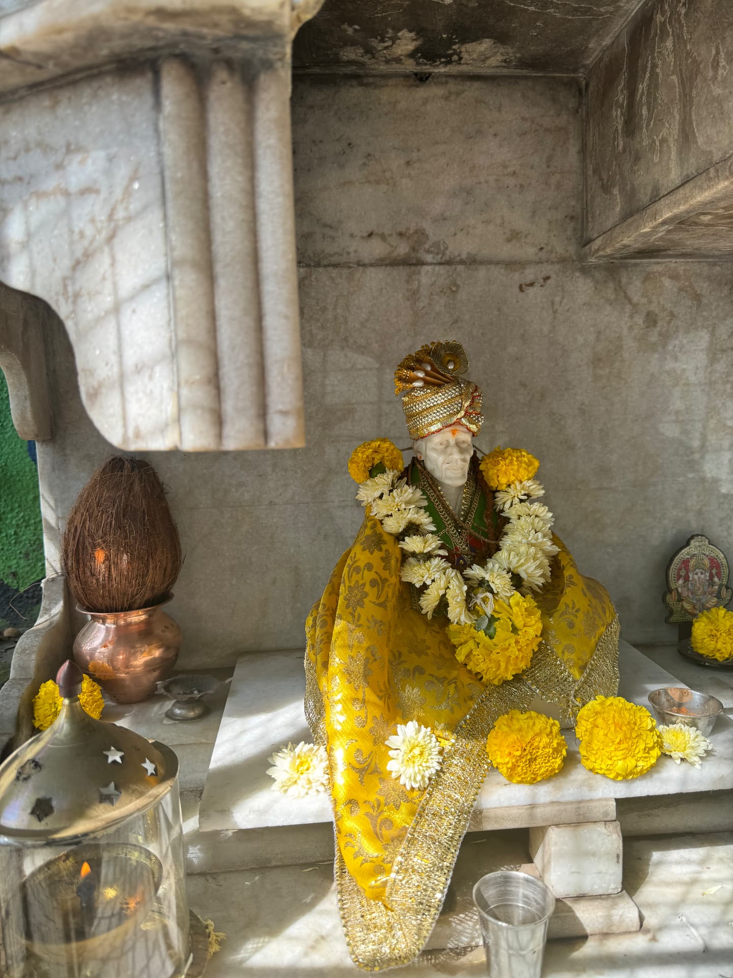 Marble shrine dressed in marigolds and jasmine