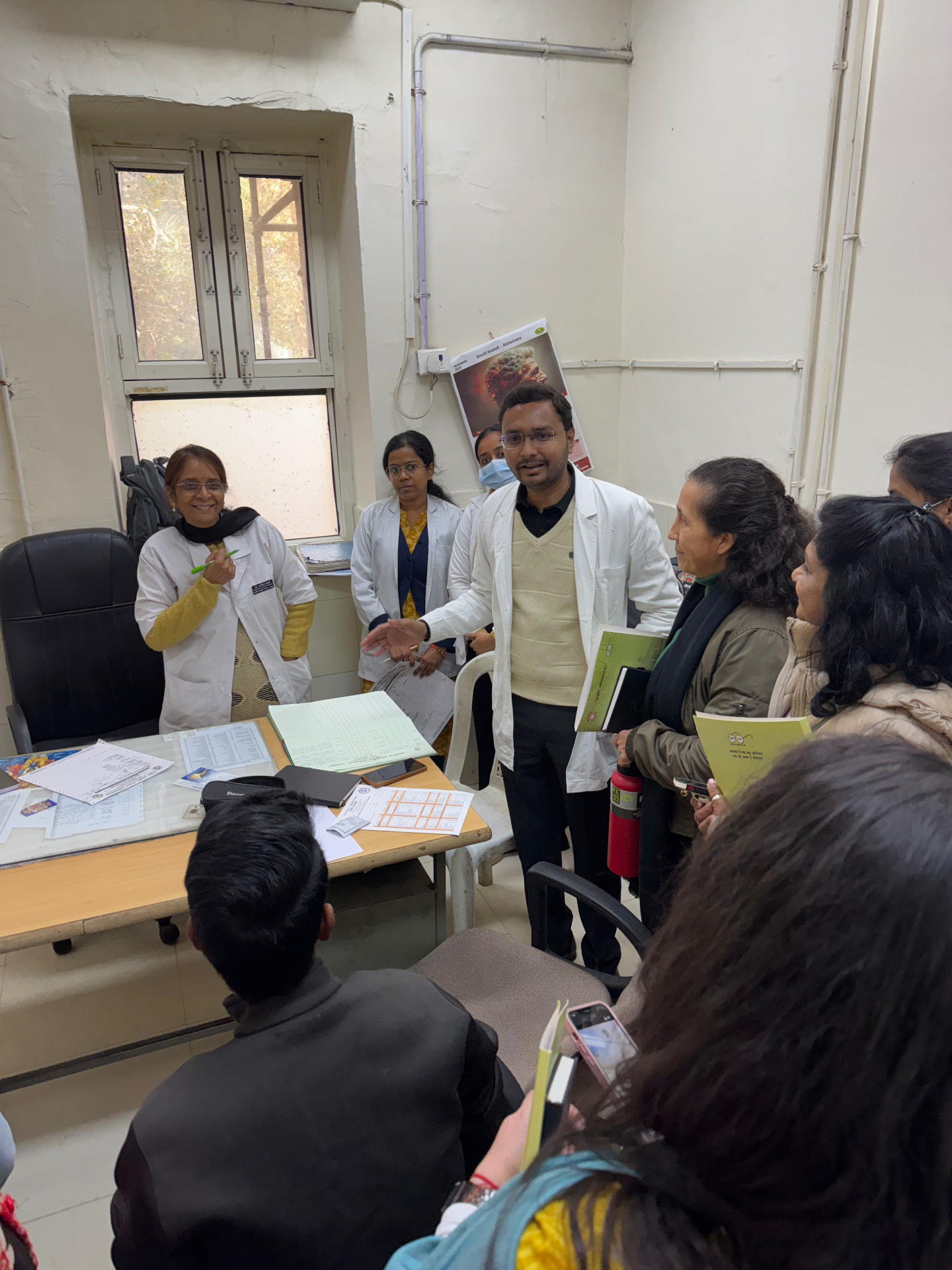 Doctors presenting a case to the group inside the hospital