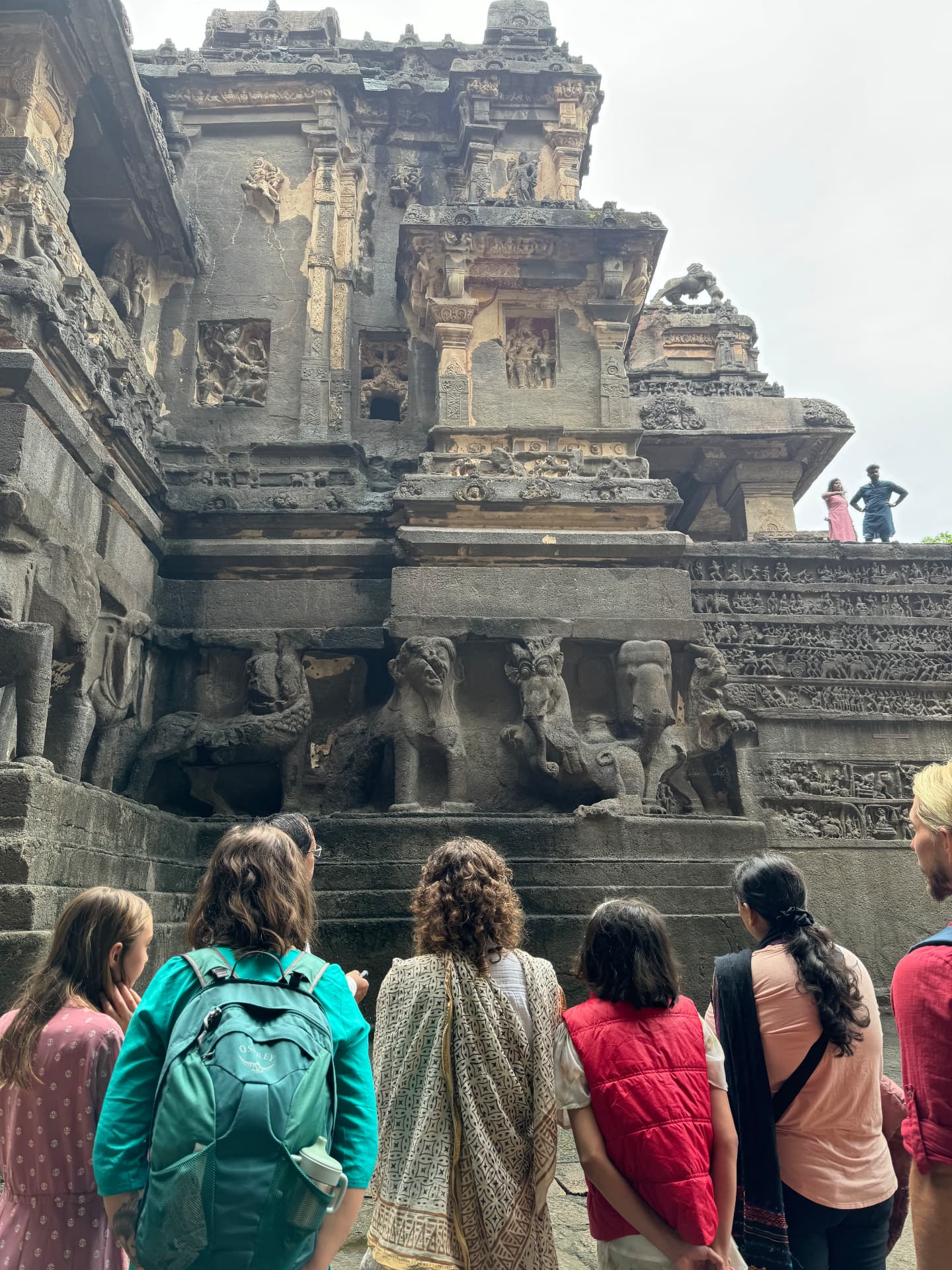 The group studying the carved rock temple at Ellora